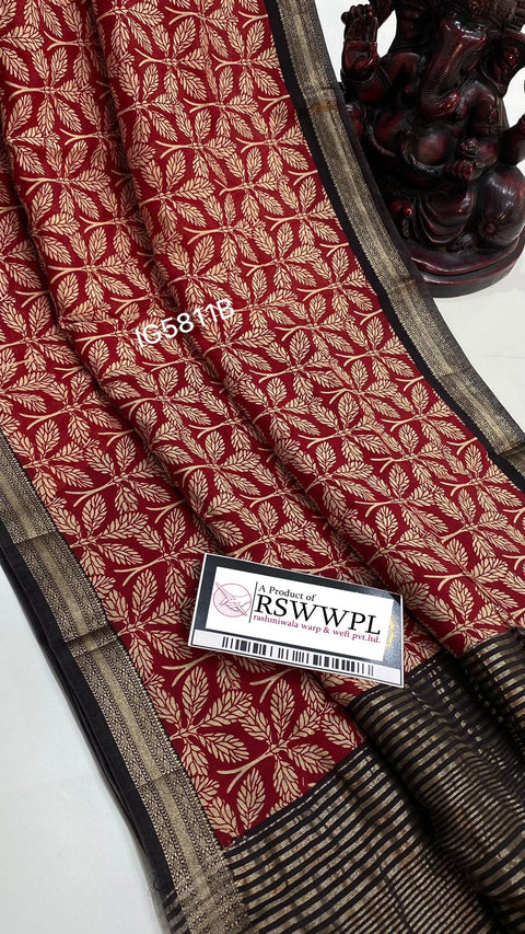 Elegant Dola silk saree, adorned with chic leaf print and tassels, featuring white, red, and black hues, symbolizing timeless elegance