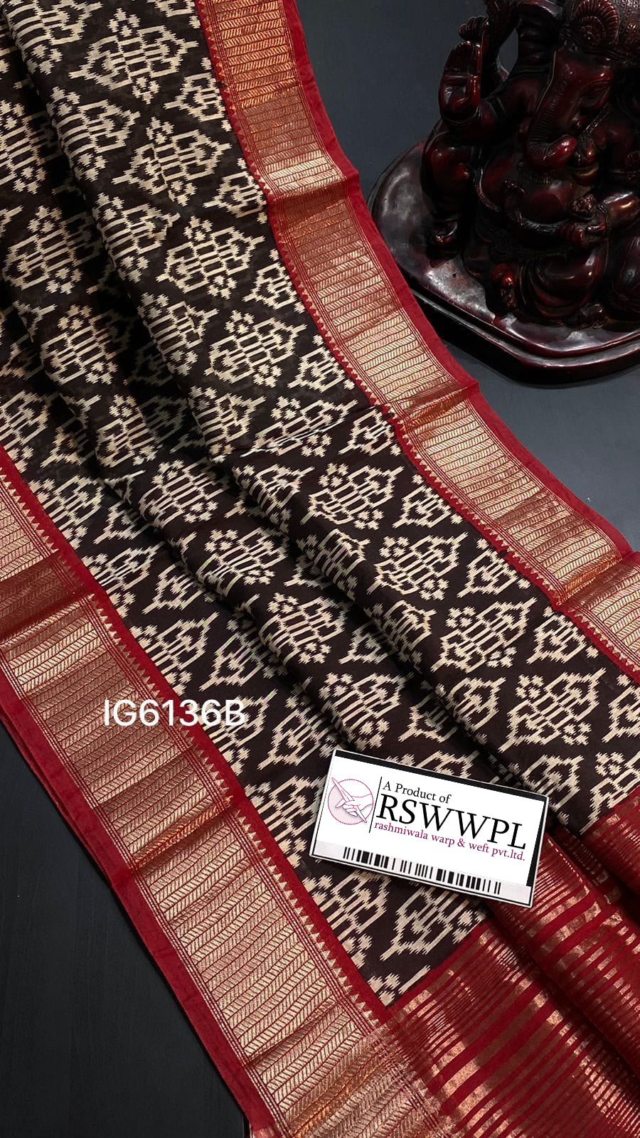 Black floral print saree with striking contrast border, elegant sophistication.