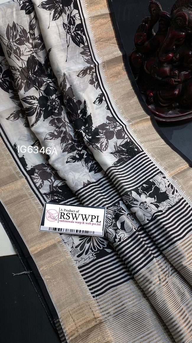 White nd Black  Lightweight, soft Assam silk with woven border and beautiful prints.