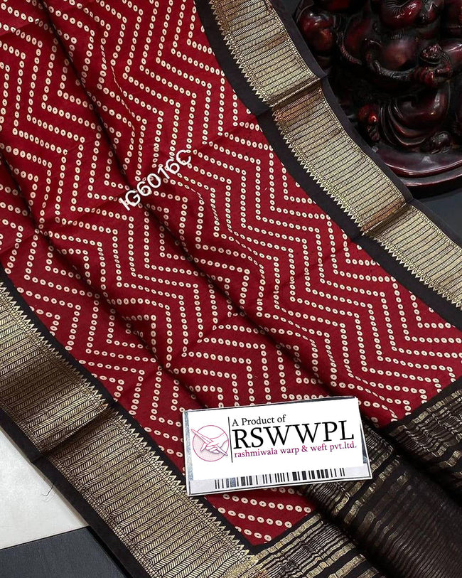 Red Lightweight, soft Assam silk with woven border and beautiful prints.